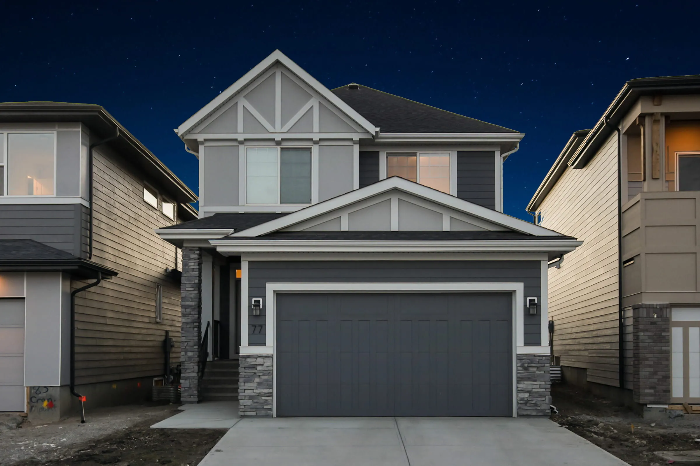 Two-storey home at dusk with the permanent lighting switched off; the track is hard to see under the eaves