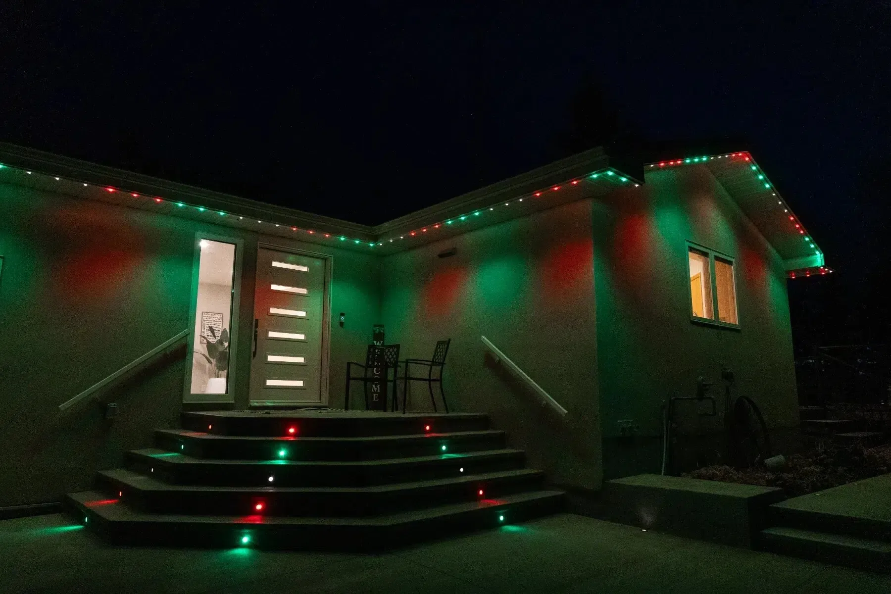 Back steps and roofline lit red and green for Christmas