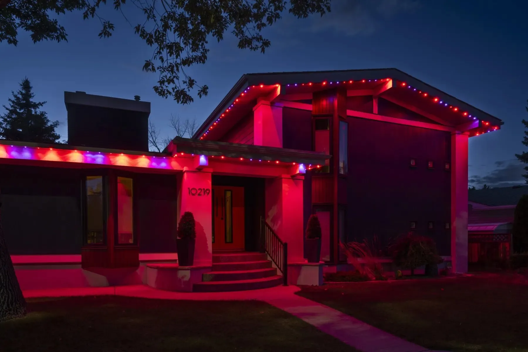 Bungalow lit in deep red at night