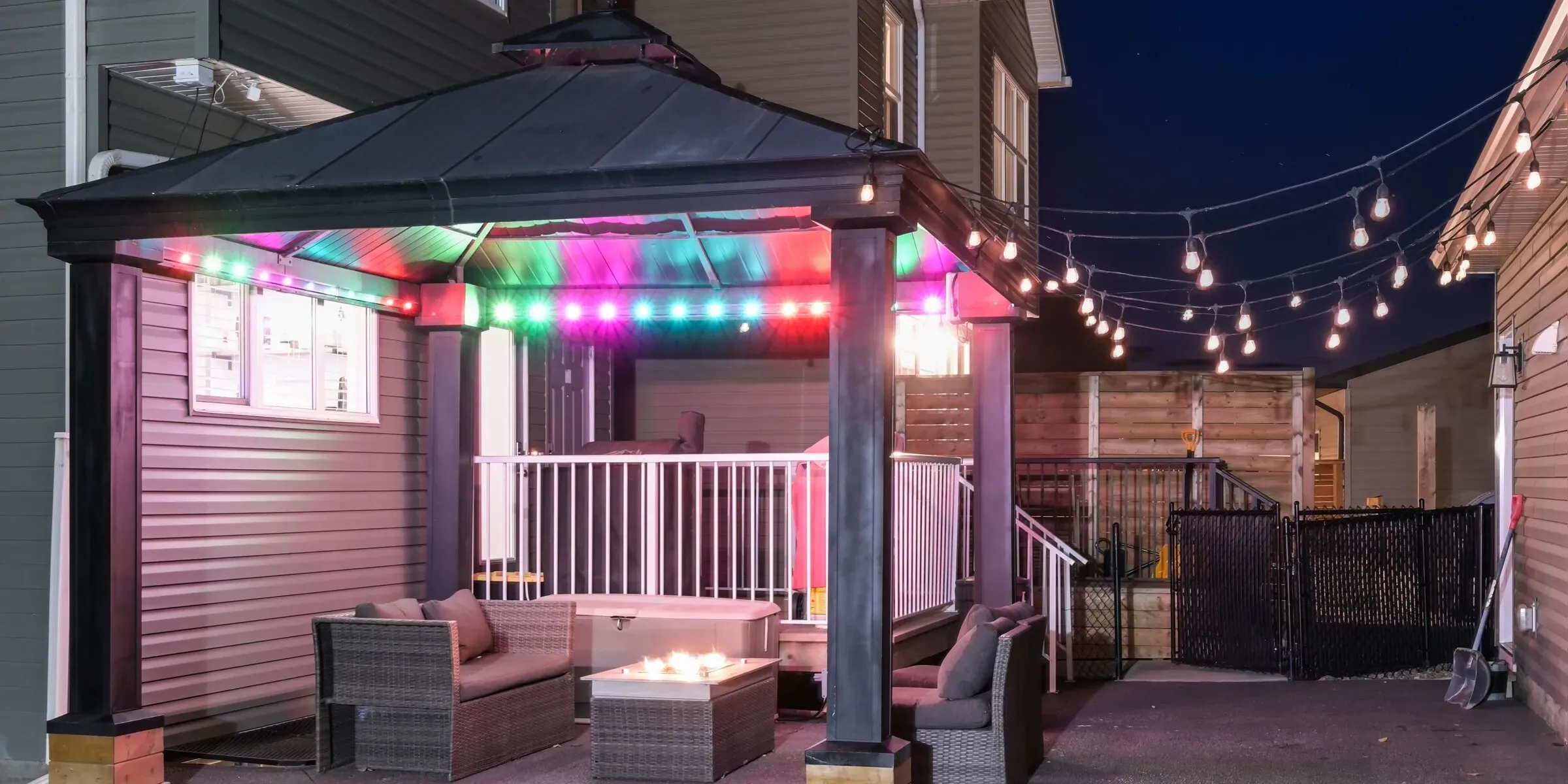 Pergola with colourful string lights at night