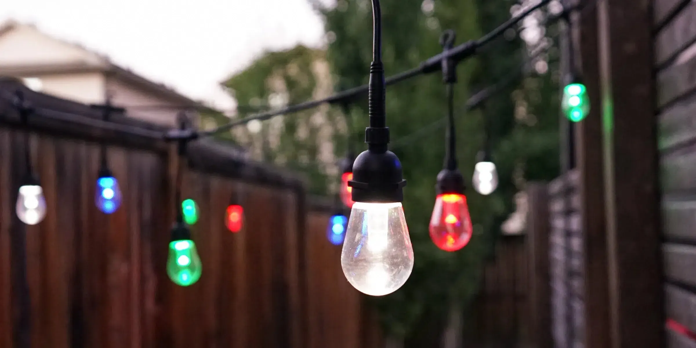 String lights along a wood fence