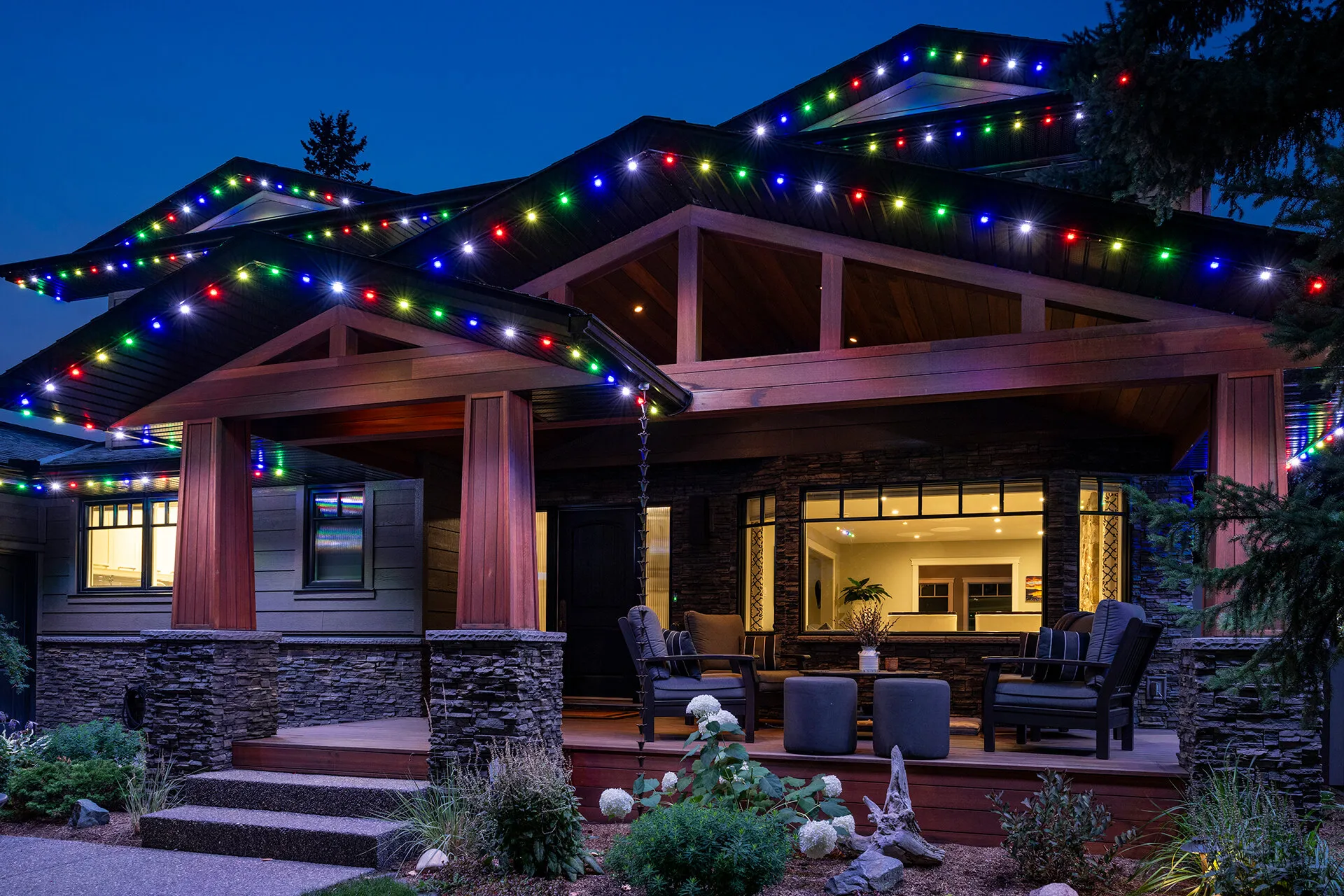 Craftsman home with multicolour Christmas lights along the roofline